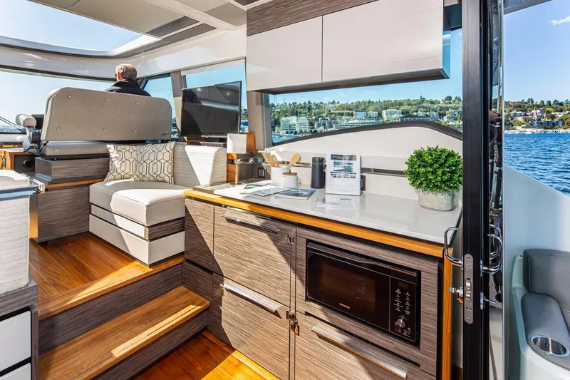 Slide: The Image of Interior of 2020 Tiara Yachts 49 COUPE with modern kitchen and seating area. - 10