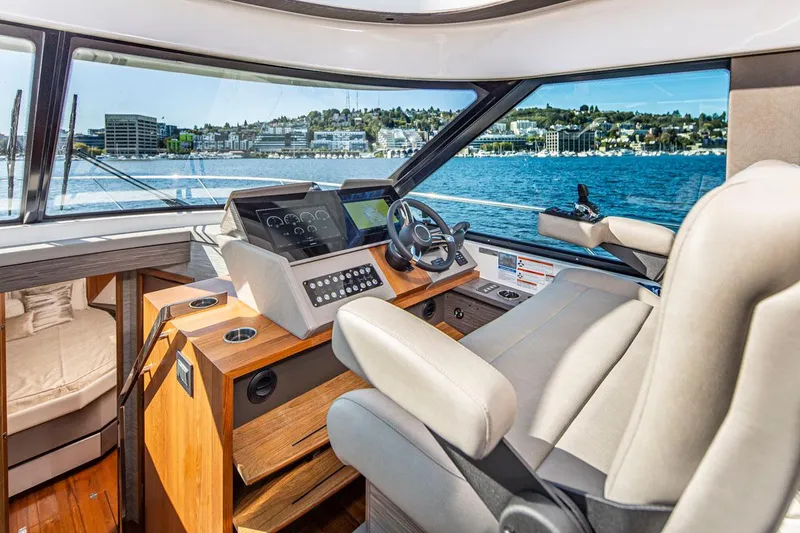 Slide: The Image of Interior helm of 2020 Tiara Yachts 49 COUPE with waterfront view. - 15