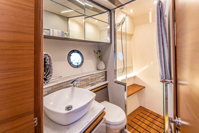 Slide: The Image of Luxurious bathroom in 2020 Tiara Yachts 49 COUPE with modern fixtures and wooden accents. - 29