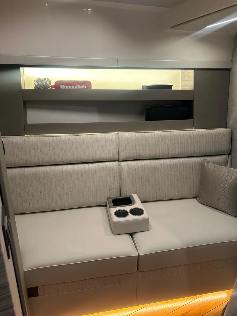 Slide: The Image of Modern interior of 2020 Tiara Yachts 49 COUPE with beige seating and cup holders. - 30