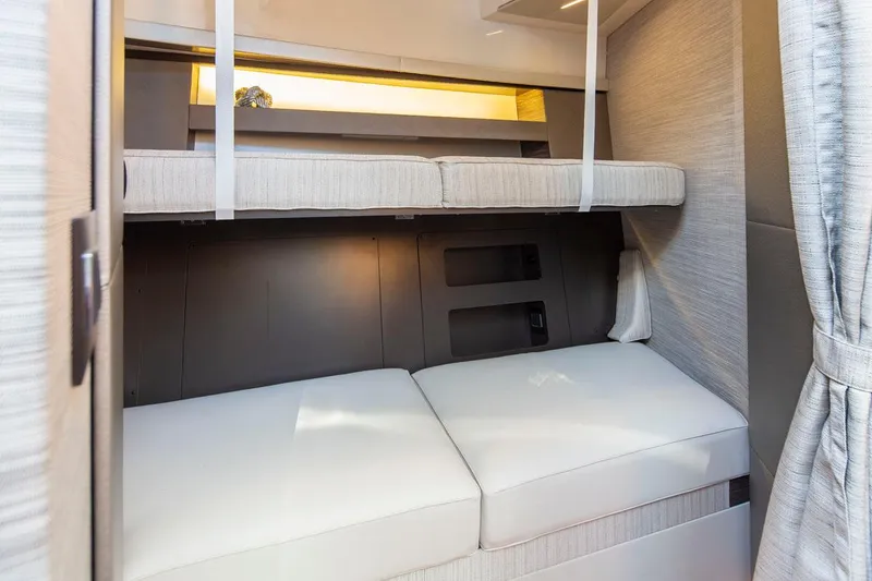 Slide: The Image of 2020 Tiara Yachts 49 COUPE interior cabin with bunk beds. - 31