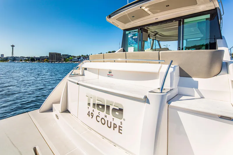 Slide: The Image of 2020 Tiara Yachts 49 COUPE on water with city skyline in background. - 5