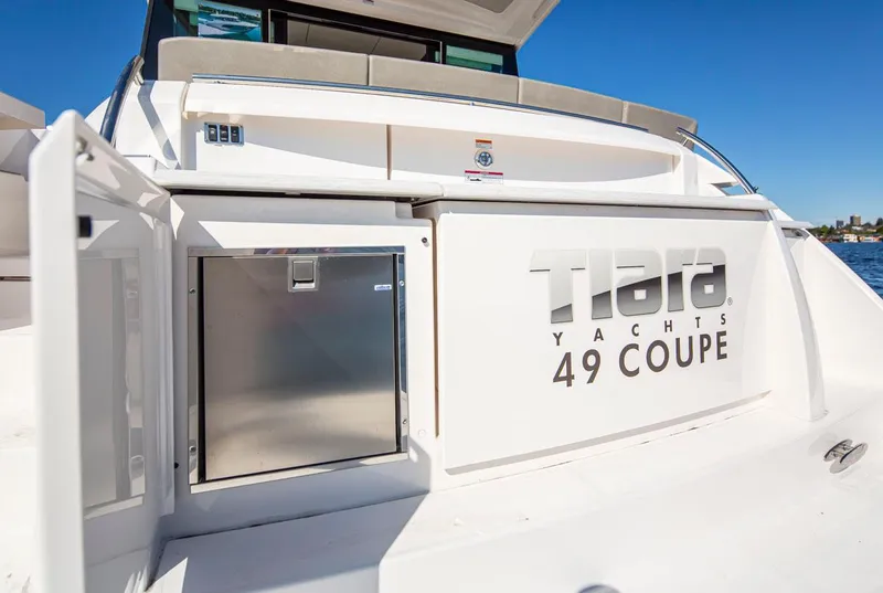 Slide: The Image of 2020 Tiara Yachts 49 Coupe stern view with logo and storage compartment. - 6
