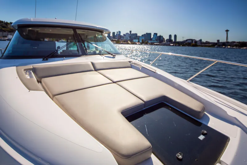 Slide: The Image of 2020 Tiara Yachts 49 COUPE on water with city skyline in background. - 7