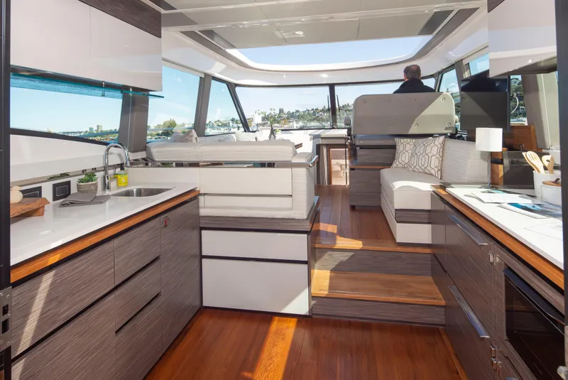 Slide: The Image of Interior of 2020 Tiara Yachts 49 COUPE with modern kitchen and seating area. - 9