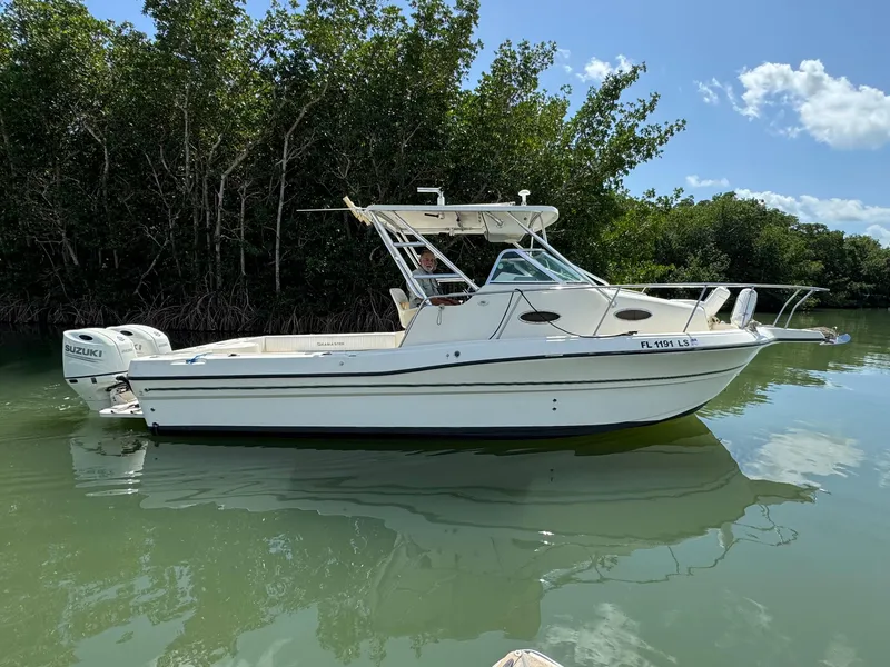Slide: The Image of 2002 Seamaster 2800 Walkaround boat on calm water near mangroves. - 1