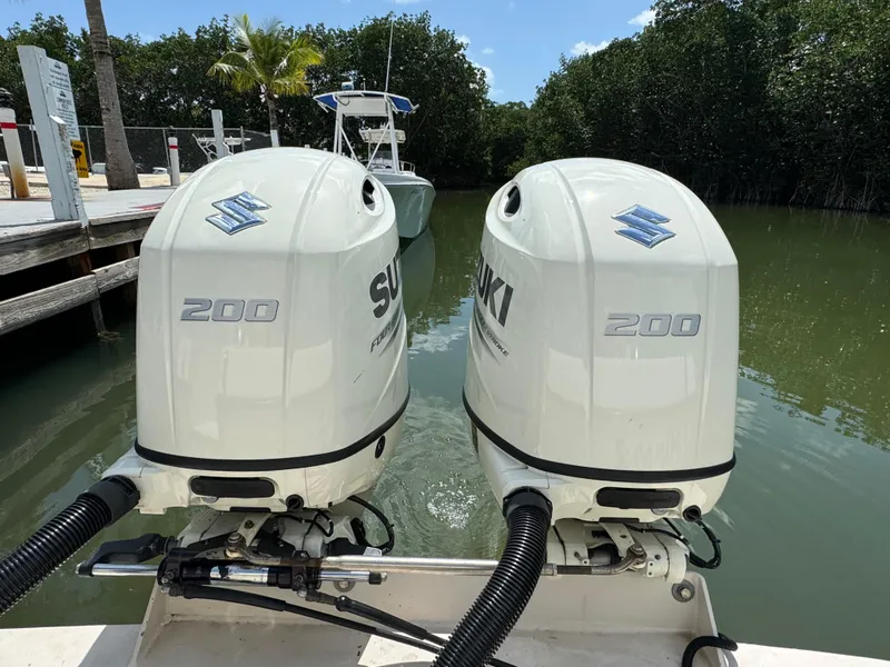 Slide: The Image of Twin Suzuki 200 outboard motors on a 2002 Seamaster 2800 Walkaround boat. - 11