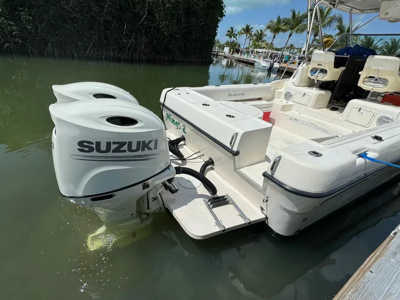 Slide: The Image of 2002 Seamaster 2800 Walkaround boat with twin Suzuki outboard motors. - 12
