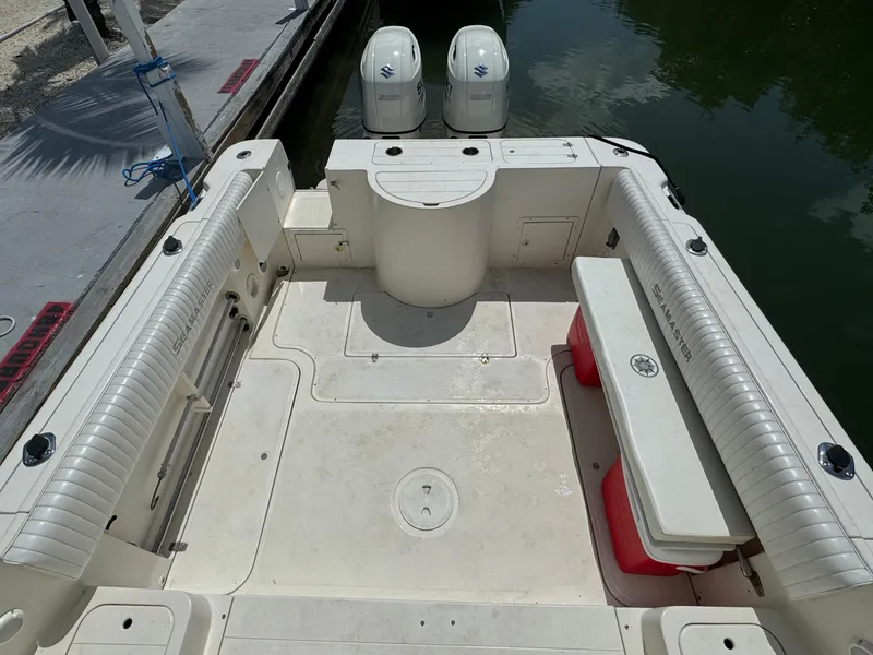 Slide: The Image of 2002 Seamaster 2800 Walkaround boat with twin outboard engines, docked. - 14