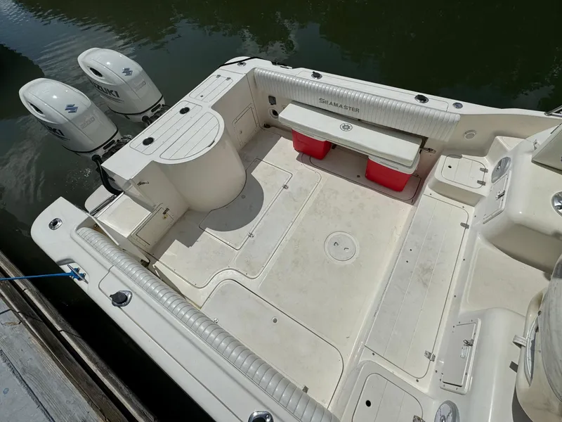 Slide: The Image of 2002 Seamaster 2800 Walkaround boat with twin outboard motors docked. - 15
