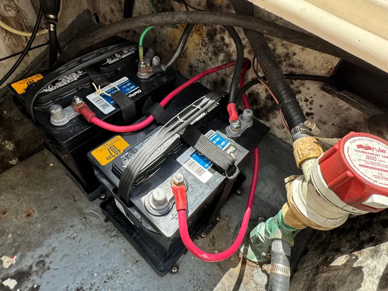 Slide: The Image of Seamaster 2800 Walkaround 2002 boat battery compartment with dual batteries and wiring. - 21