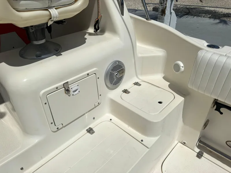 Slide: The Image of 2002 Seamaster 2800 Walkaround boat interior with storage compartments and seating. - 27
