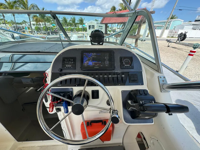 Slide: The Image of Seamaster 2800 Walkaround 2002 boat dashboard with steering wheel and navigation controls. - 31