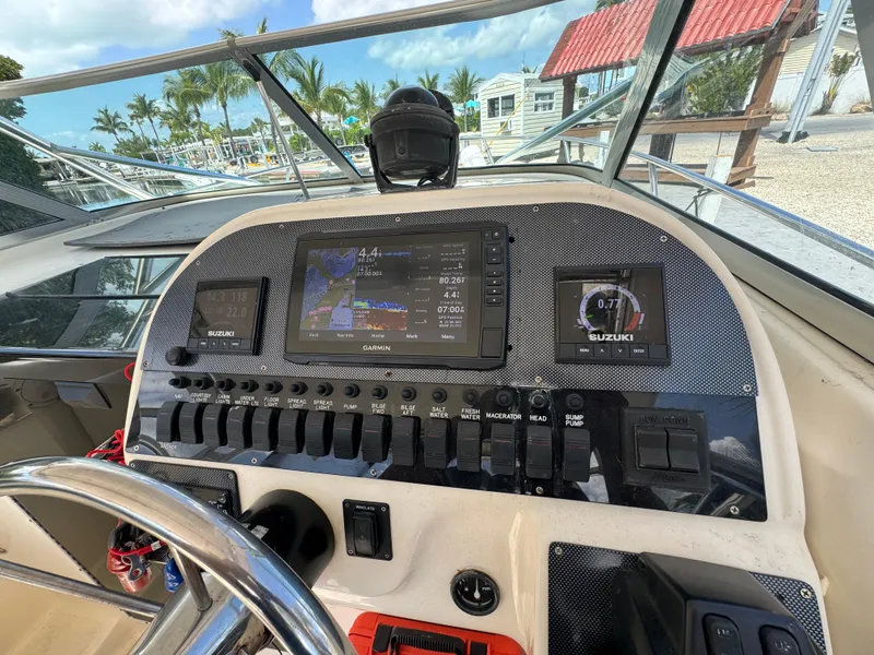 Slide: The Image of 2002 Seamaster 2800 Walkaround boat dashboard with navigation and control systems. - 32