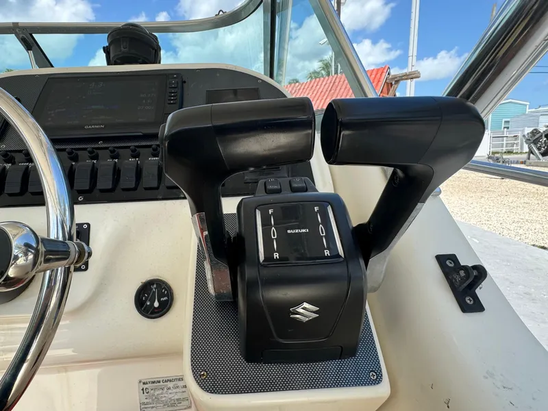 Slide: The Image of Close-up of the helm controls on a 2002 Seamaster 2800 Walkaround boat. - 33
