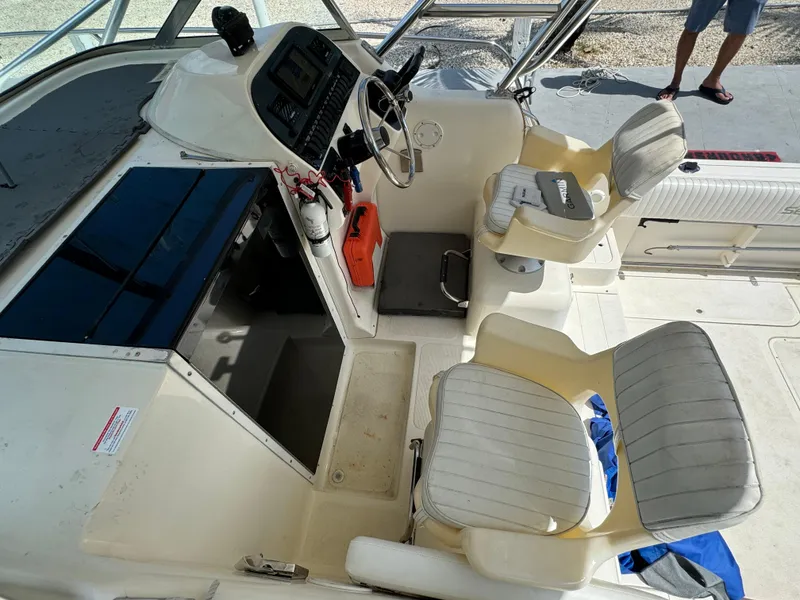 Slide: The Image of 2002 Seamaster 2800 Walkaround boat interior with helm and seating. - 34
