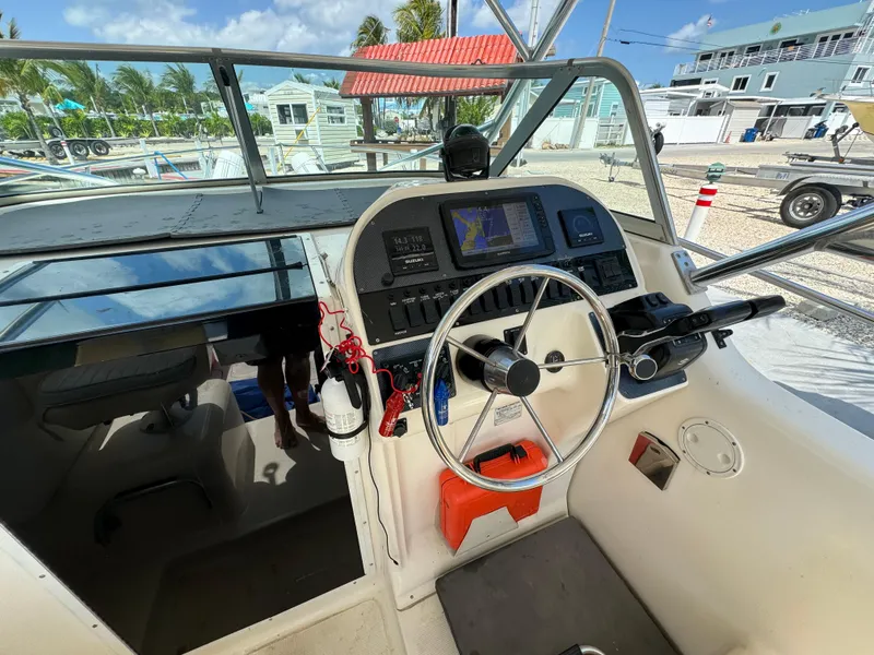 Slide: The Image of Seamaster 2800 Walkaround 2002 boat cockpit with steering wheel and navigation equipment. - 35