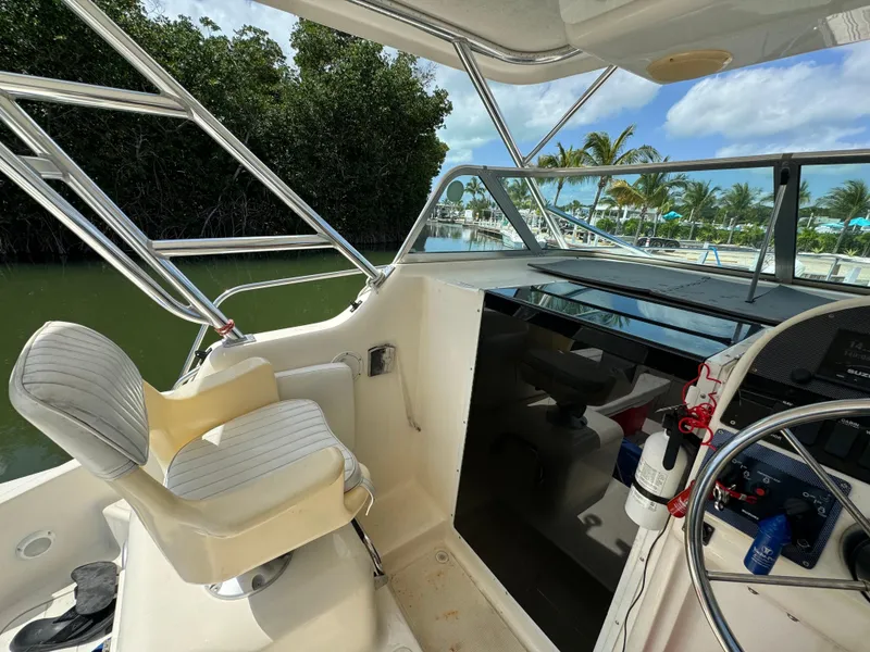Slide: The Image of 2002 Seamaster 2800 Walkaround boat cockpit with helm and seating. - 36