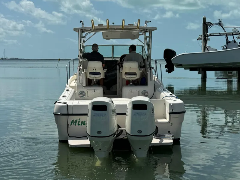 Slide: The Image of 2002 Seamaster 2800 Walkaround boat with twin engines on calm water. - 4