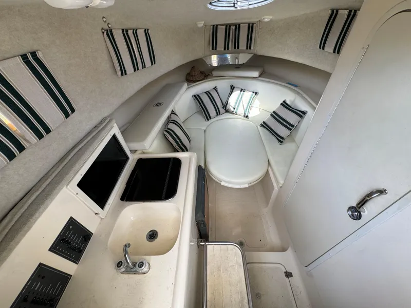 Slide: The Image of Interior of 2002 Seamaster 2800 Walkaround boat with kitchenette and seating area. - 43