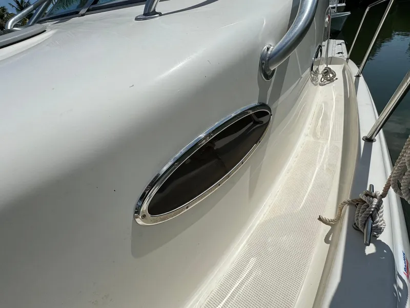 Slide: The Image of 2002 Seamaster 2800 Walkaround boat deck with stainless steel handrails and oval window. - 45