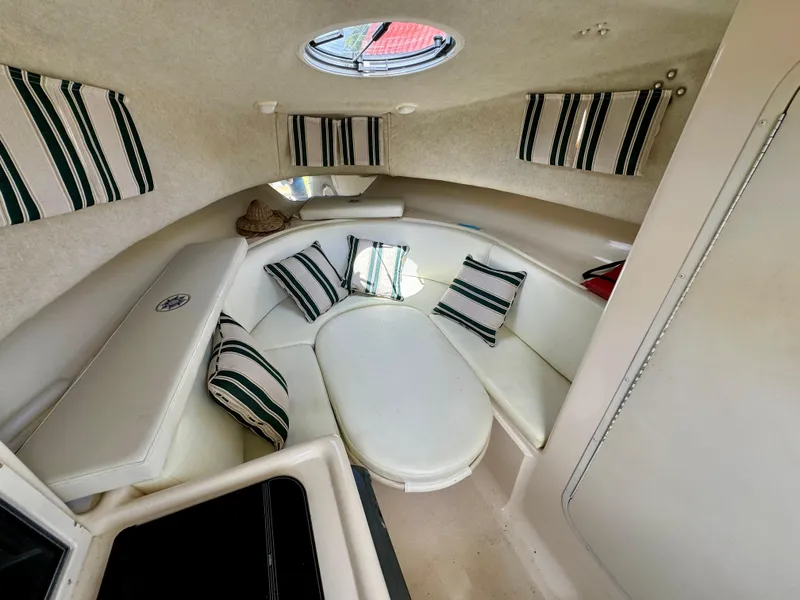Slide: The Image of Interior cabin of 2002 Seamaster 2800 Walkaround boat with striped cushions. - 47