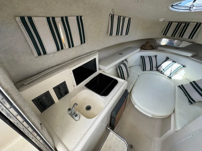 Slide: The Image of Interior of 2002 Seamaster 2800 Walkaround boat with kitchenette and seating area. - 48