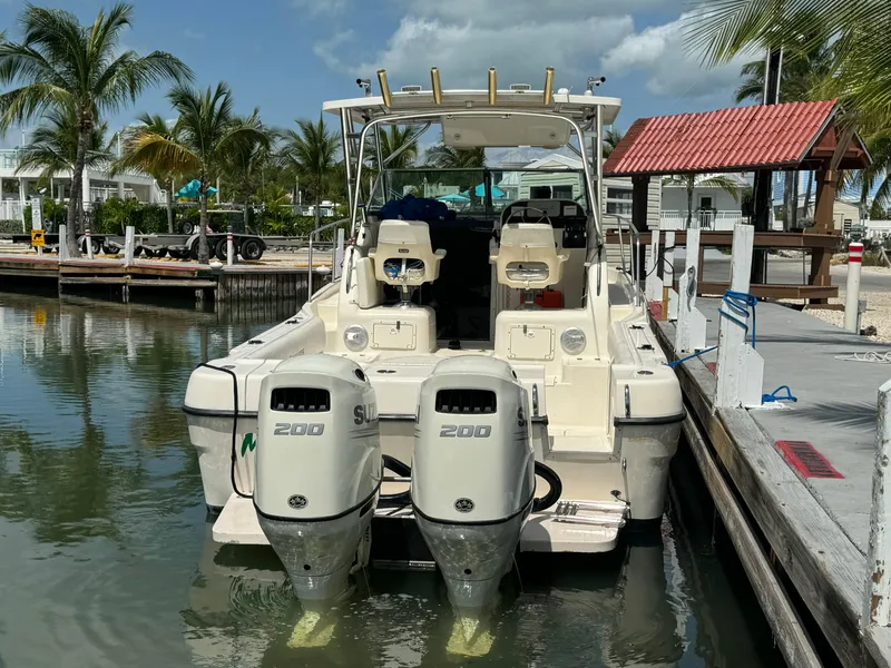 Slide: The Image of 2002 Seamaster 2800 Walkaround boat docked with twin Suzuki 200 engines. - 9