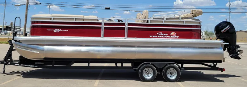 The Image of 2024 Sun Tracker Party Barge 24 DLX pontoon boat on trailer, side view. - 0