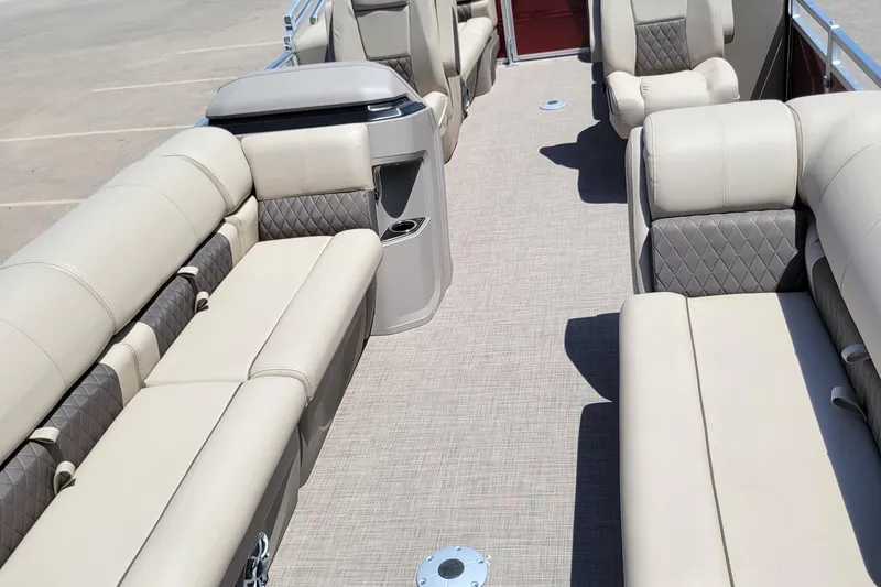 Slide: The Image of 2024 Sun Tracker Party Barge 24 DLX interior with beige seating and spacious layout. - 3