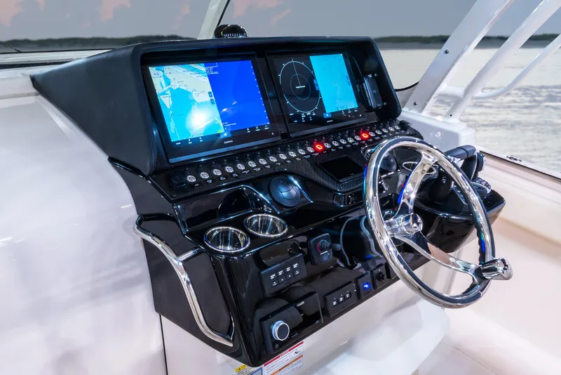 Slide: The Image of 2024 Grady-White 386 Canyon boat dashboard with advanced navigation systems. - 3