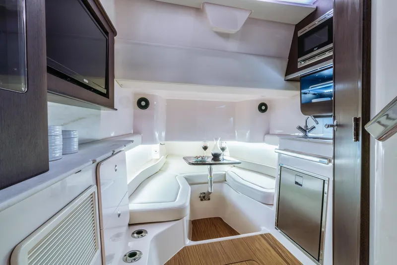 Slide: The Image of 2024 Grady-White 386 Canyon boat interior with modern kitchen and seating area. - 4