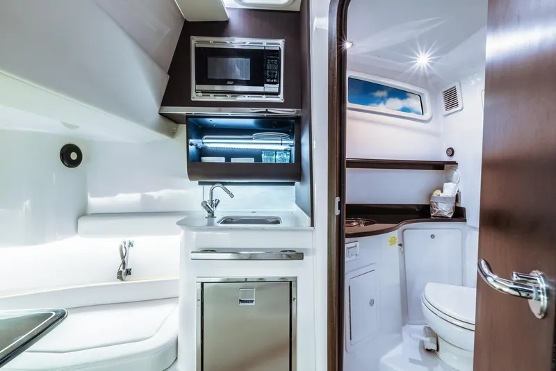Slide: The Image of 2024 Grady-White 386 Canyon boat interior with kitchenette and bathroom. - 5