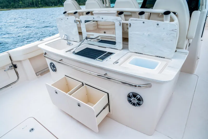 Slide: The Image of 2024 Grady-White 386 Canyon boat with open storage compartments and fishing amenities. - 8