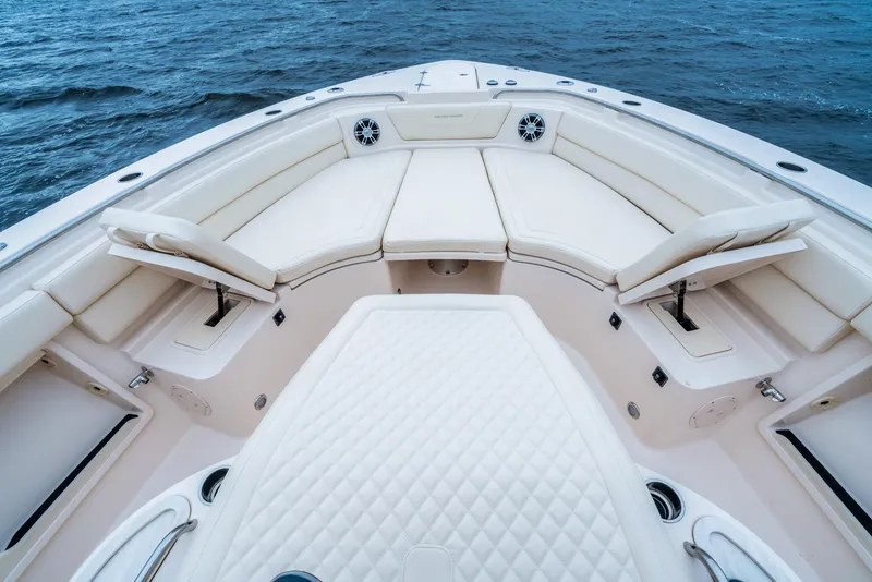 Slide: The Image of 2024 Grady-White 386 Canyon boat interior with white cushioned seating. - 9