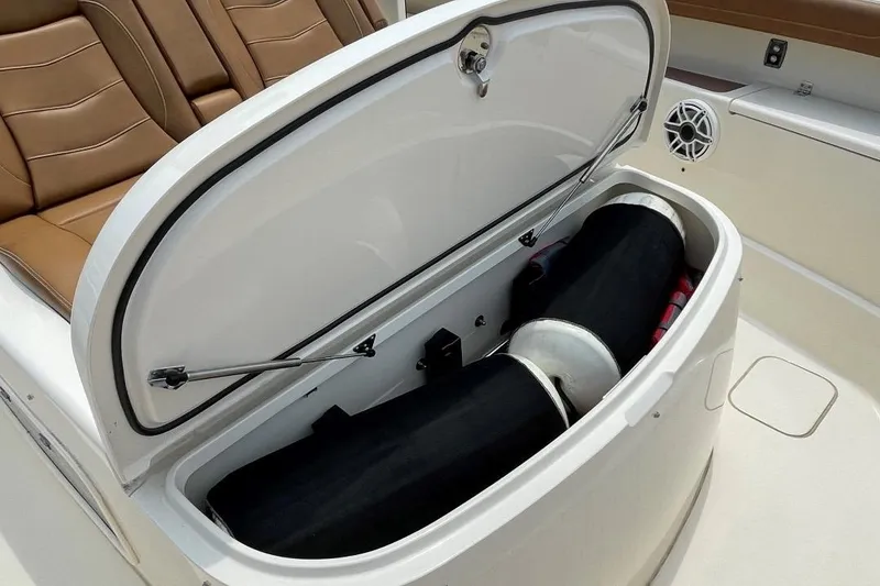 Slide: The Image of 2020 Scout 420 LXF boat storage compartment with open lid. - 14