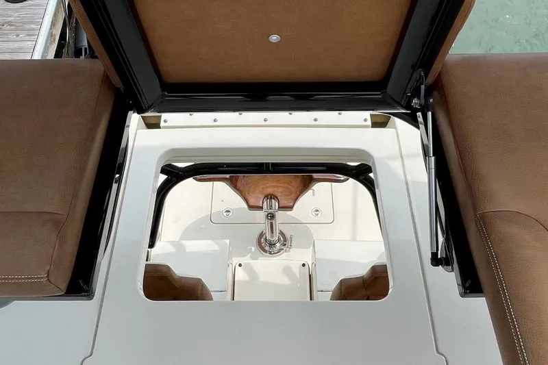 Slide: The Image of 2020 Scout 420 LXF boat interior with brown seating and control panel. - 17