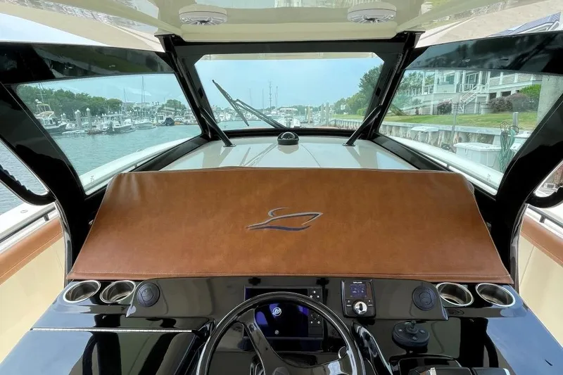 Slide: The Image of 2020 Scout 420 LXF boat helm with leather dashboard cover. - 24