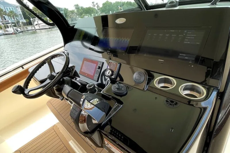 Slide: The Image of 2020 Scout 420 LXF boat dashboard with steering wheel and navigation controls. - 27