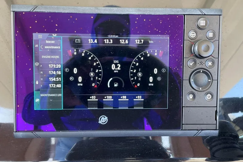 Slide: The Image of 2020 Scout 420 LXF boat dashboard display showing engine hours and maintenance info. - 31