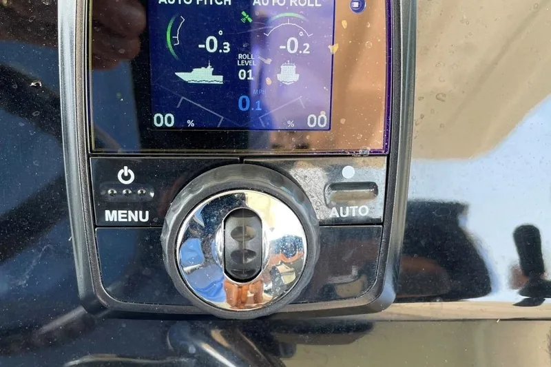 Slide: The Image of Control panel of a 2020 Scout 420 LXF boat showing auto pitch and roll settings. - 32