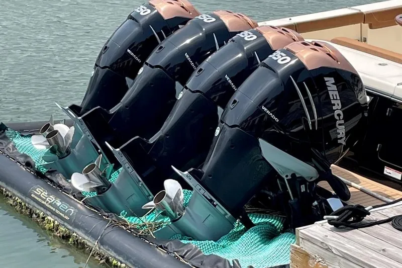 Slide: The Image of Quad Mercury outboard engines on a 2020 Scout 420 LXF boat docked. - 41