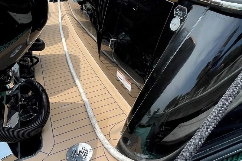 Slide: The Image of 2020 Scout 420 LXF boat deck with teak flooring and black exterior. - 46