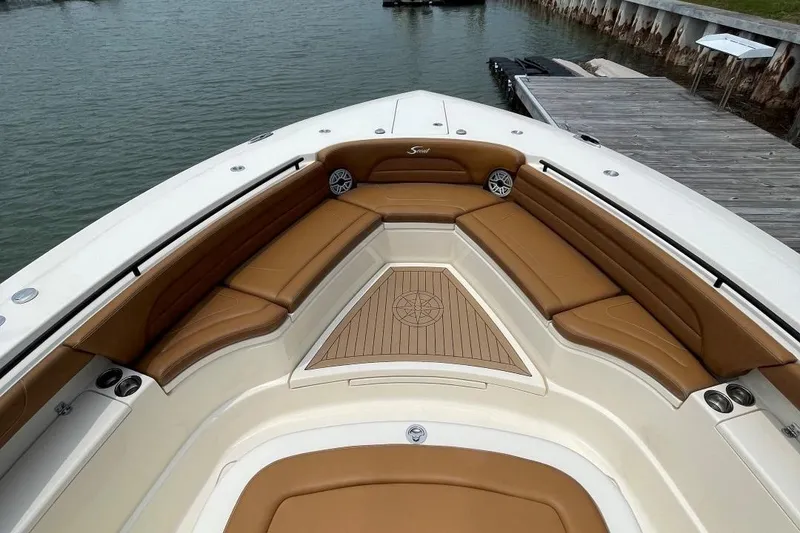 Slide: The Image of 2020 Scout 420 LXF boat with tan seating and spacious deck. - 6