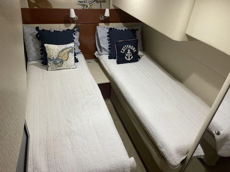 Slide: The Image of Twin beds in the cabin of a 2009 Formula 45 Yacht, with nautical-themed pillows. - 12