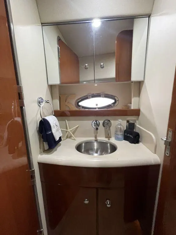 Slide: The Image of 2009 Formula 45 Yacht bathroom with sink, mirror, and storage cabinets. - 14