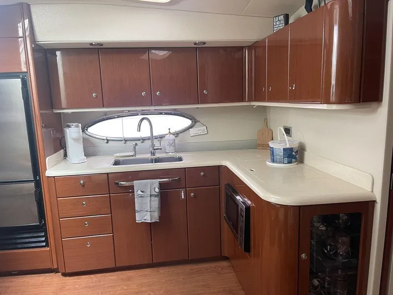 Slide: The Image of 2009 Formula 45 Yacht kitchen with wooden cabinets and modern appliances. - 17