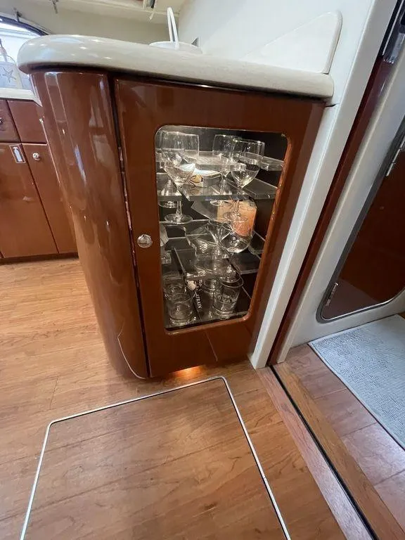 Slide: The Image of 2009 Formula 45 Yacht interior with glass cabinet and wooden flooring. - 18