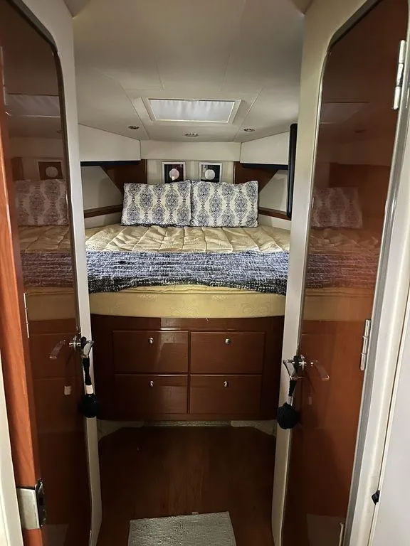 Slide: The Image of Interior cabin of a 2009 Formula 45 Yacht with a cozy bed and wooden cabinetry. - 5