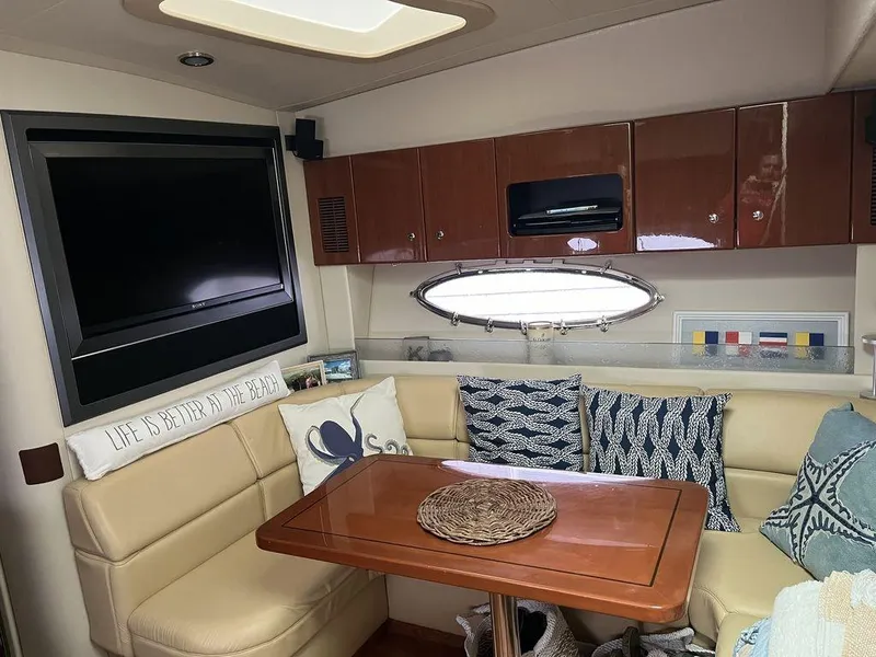 Slide: The Image of Interior of 2009 Formula 45 Yacht with cozy seating, TV, and wooden table. - 6
